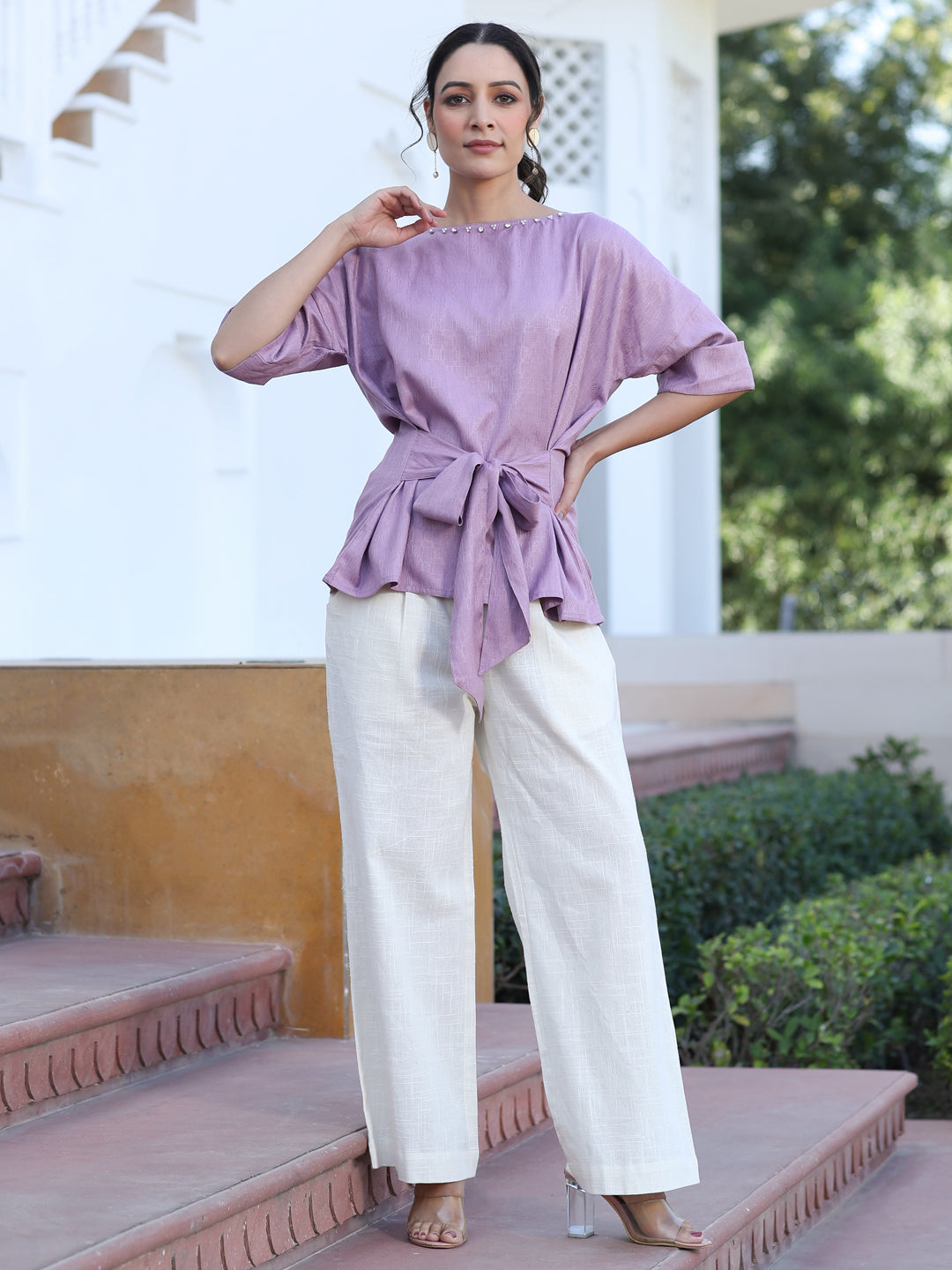 A Mauve Color Self Weaved Embellished Top With Tie-Up At The Waist And Extended Sleeves Top With Cotton Off-White Flared Pants