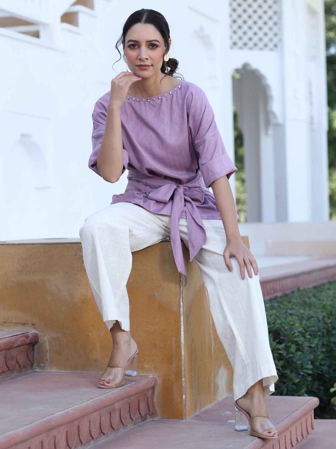 A Mauve Color Self Weaved Embellished Top With Tie-Up At The Waist And Extended Sleeves Top With Cotton Off-White Flared Pants