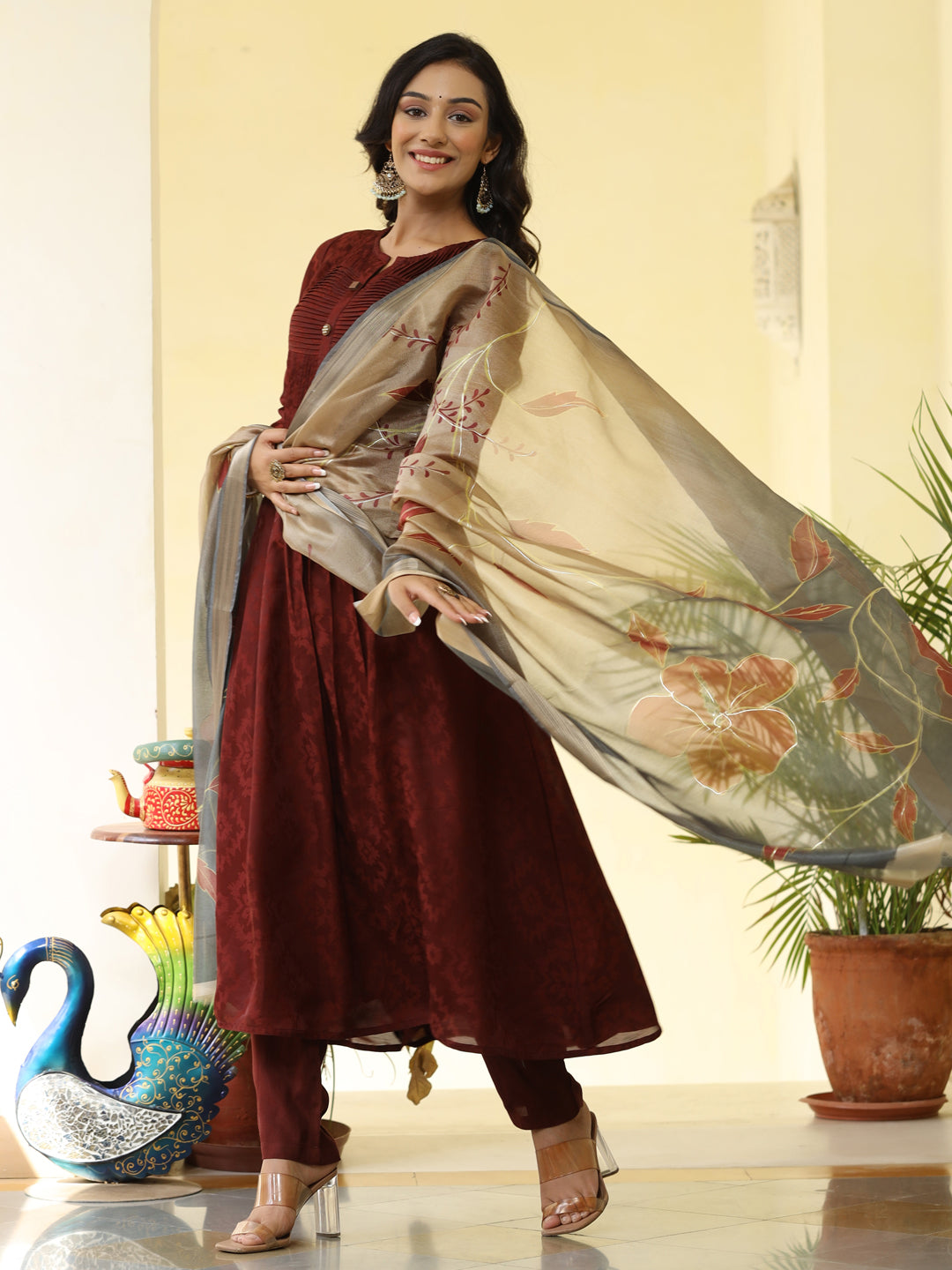Brown Silk Pleated Straight Kurta Has Round Neck, Front Placket And Buttons With Both Side Pleats, Three Fourth Regular Sleeves, Flared Hemline, Cotton Mulmul Lining Is Attached To Kurta, Brown Pants Has Both Side Pocket And Partially Elastic Waist, Organza Printed Dupatta.