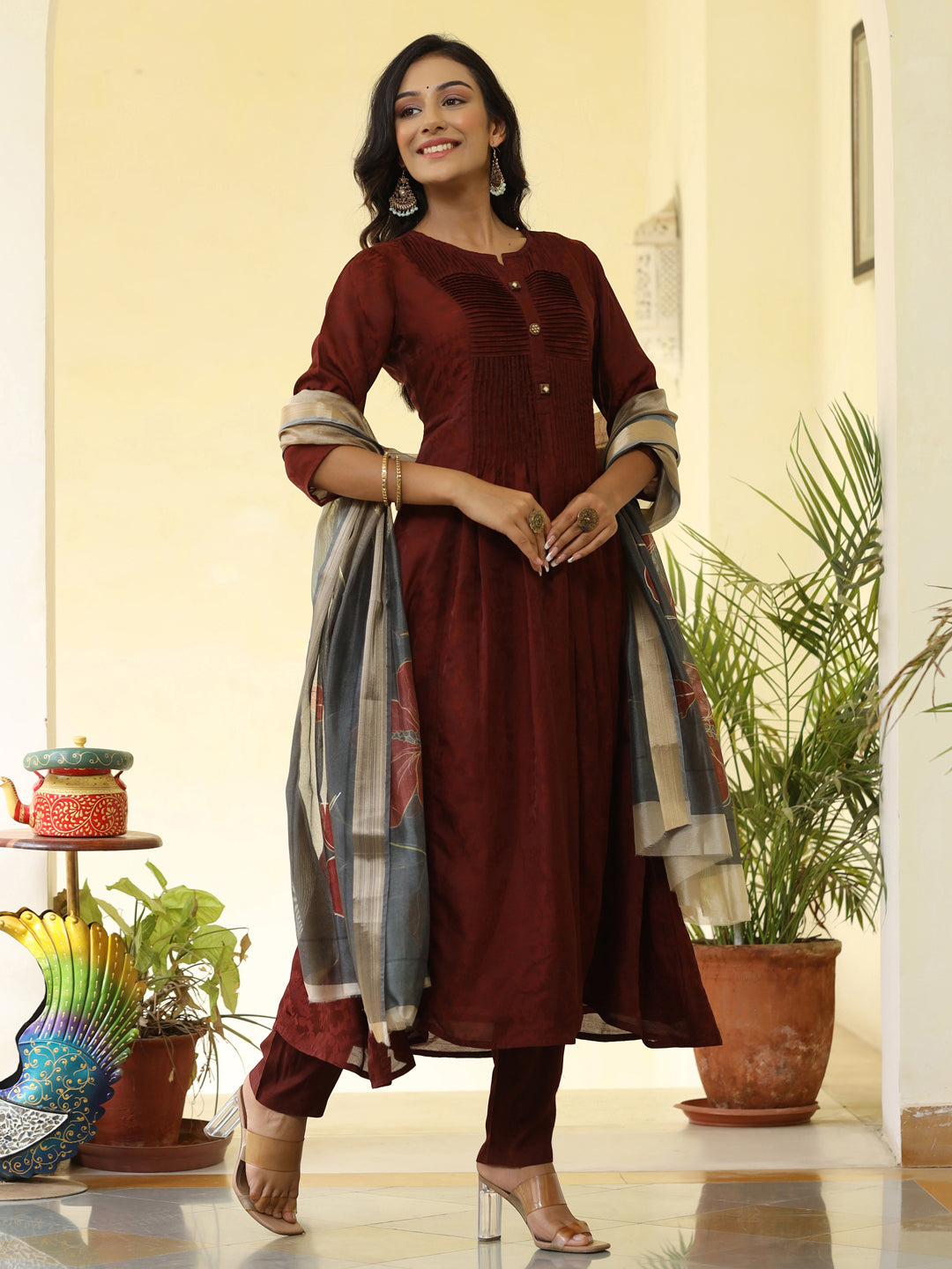 Brown Silk Pleated Straight Kurta Has Round Neck, Front Placket And Buttons With Both Side Pleats, Three Fourth Regular Sleeves, Flared Hemline, Cotton Mulmul Lining Is Attached To Kurta, Brown Pants Has Both Side Pocket And Partially Elastic Waist, Organza Printed Dupatta.